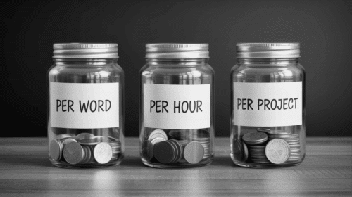 Three glass jars labeled by hand as “Per Word,” “Per Hour,” and “Per Project,”each filled with different amounts of coins, placed neatly on a wooden desk